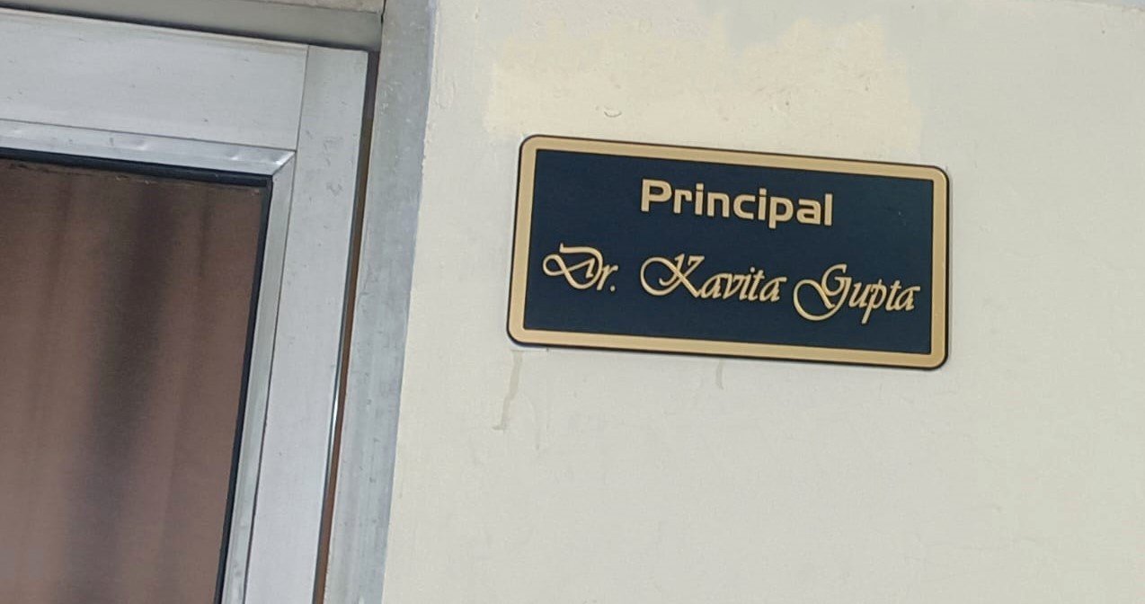 Principal desk nameplate for Dr. Kavita Gupta in navy and gold acrylic