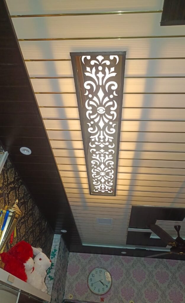 Acrylic ceiling jali panel installed in a modern home interior with illuminated decorative cutwork design